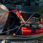car battery with jumper cables attached