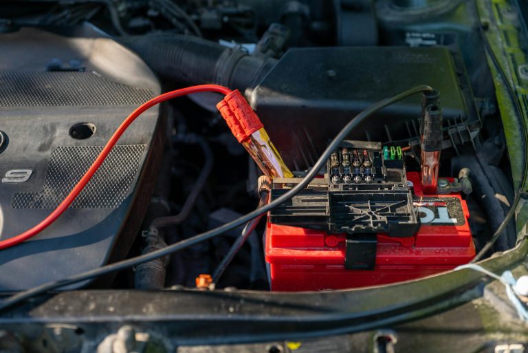 car battery with jumper cables attached